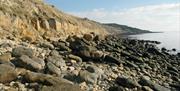 Rocky beach picture, sandy beach picture and map showing meeting point for the walk